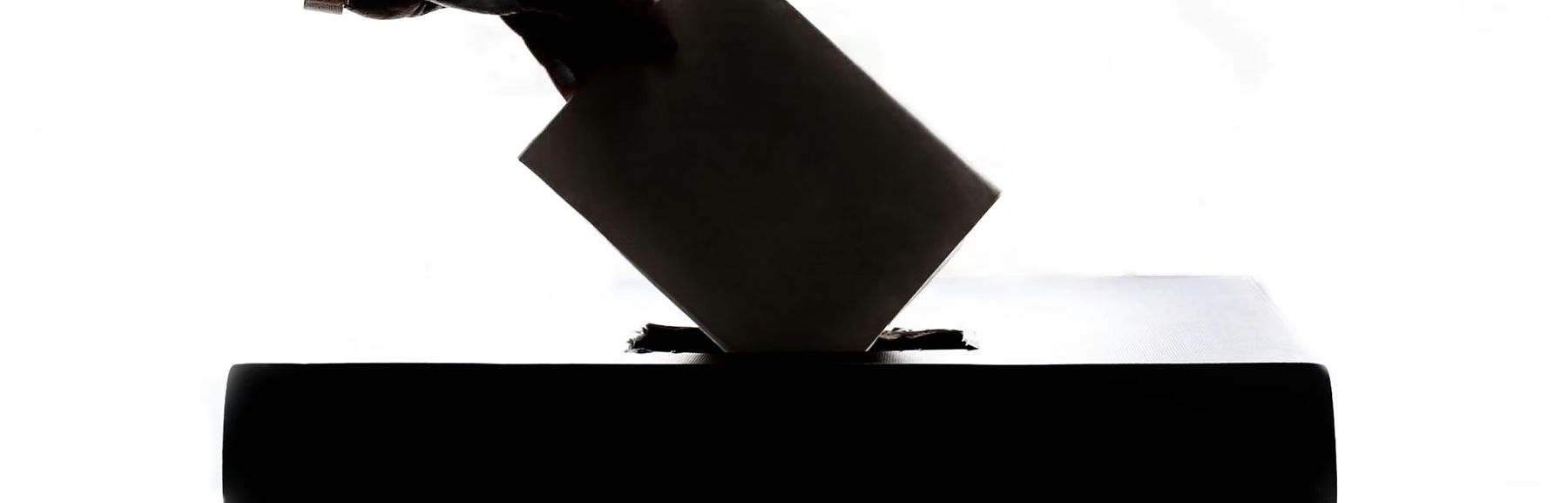 A ballot being cast into a ballot box
